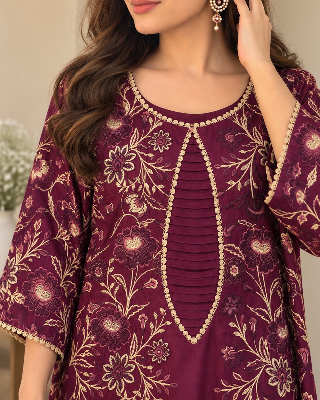 Berry Wine maroon embroidered silk kaftan, close-up of the pleated neckline and floral embroidery