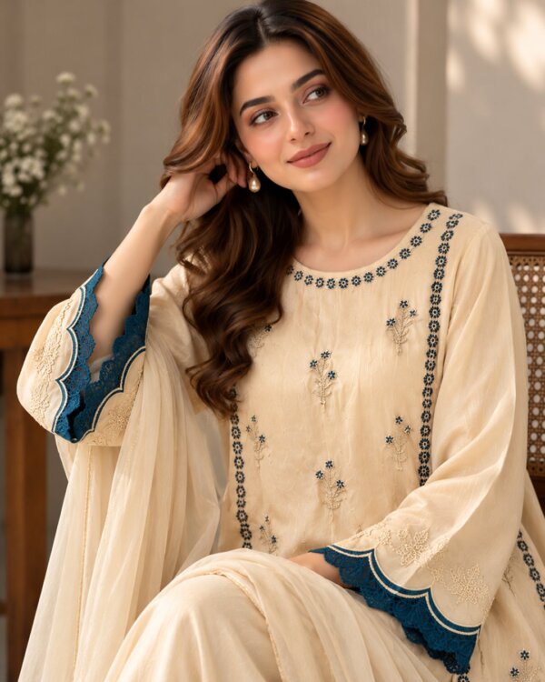 Champagne embroidered silk 3 piece suit, seated close-up showing the scalloped sleeve