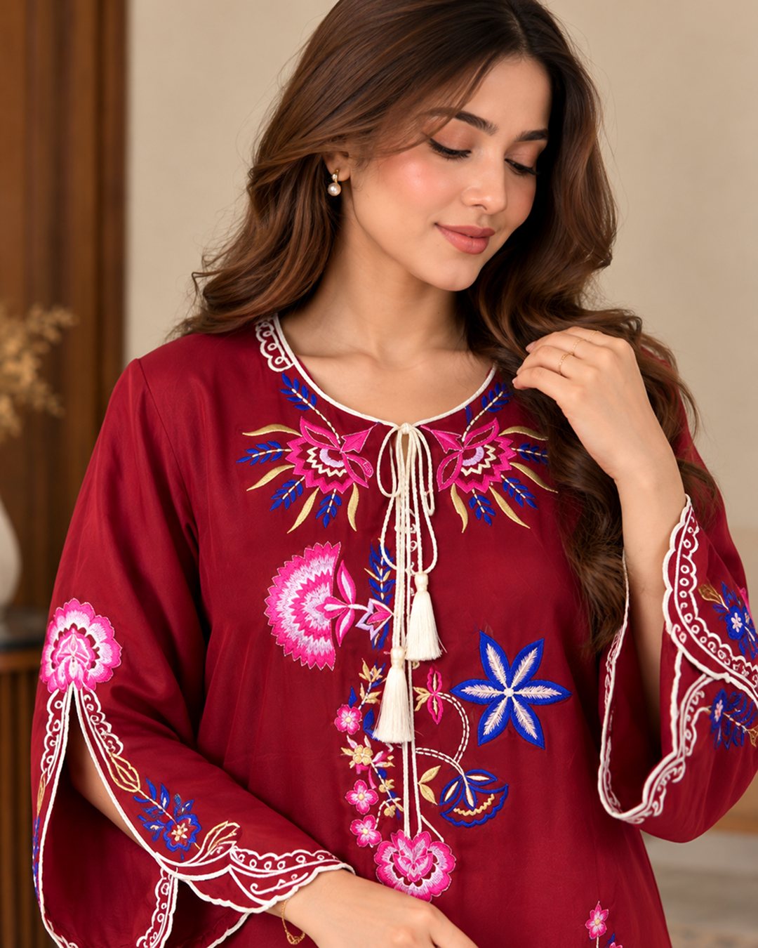 Red embroidered silk kaftan, close-up of the tassel neckline and floral embroidery