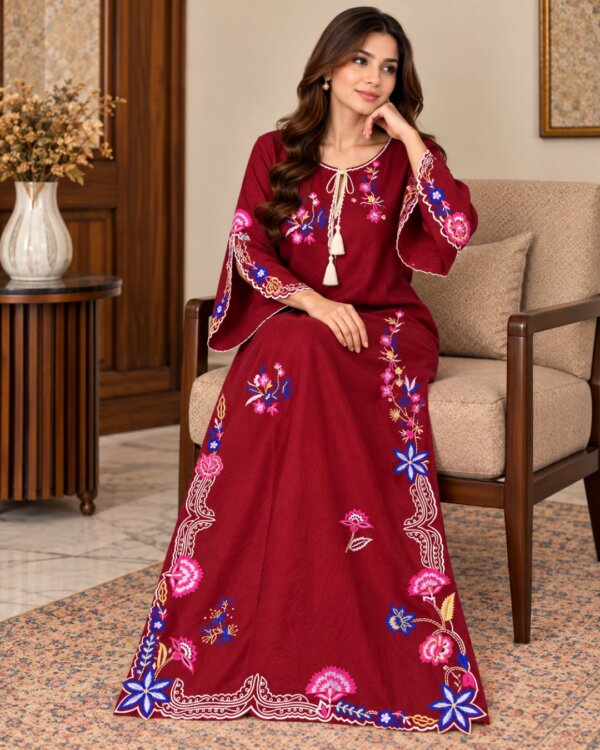 Red embroidered silk kaftan, seated on a chair, full-length front view